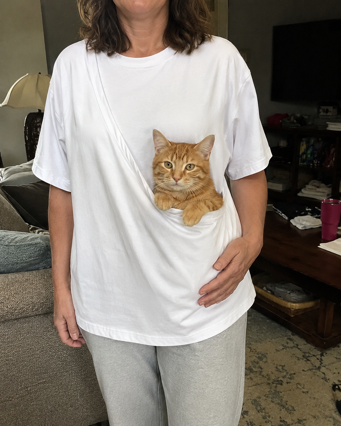 Cat comfortably sitting in the PawPal front pouch at home